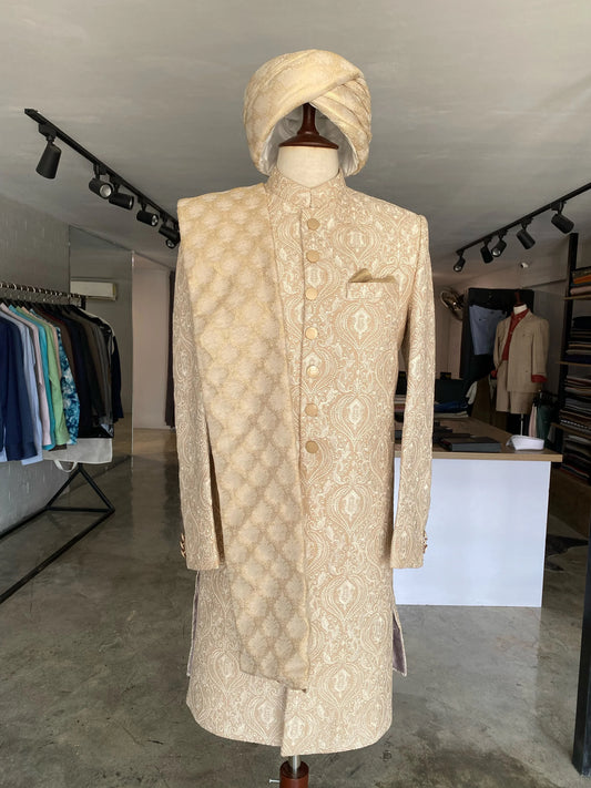 Crystal pink sherwani with beige thread work & matte gold buttons, paired with dull gold Jamawar turban. Best sherwani for dulha & groom—fresh and elegant look.