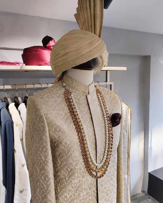 Shahjahan sand gold sherwani with resham self-embroidery from the Montazeri collection. Best sherwani for dulha and groom—crafted for elegance and grace.
