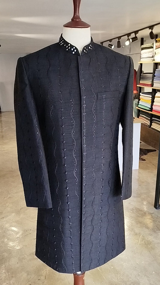 Black raw silk sherwani with self-embroidery, sequins & mirror work collar. Includes cotton silk kurta-trouser. Best sherwani for groom & dulha.