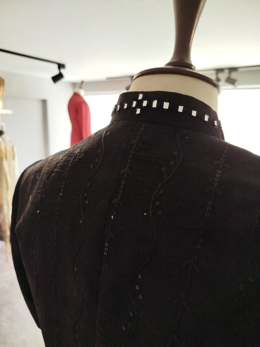 Black raw silk sherwani with self-embroidery, sequins & mirror work collar. Includes cotton silk kurta-trouser. Best sherwani for groom & dulha.