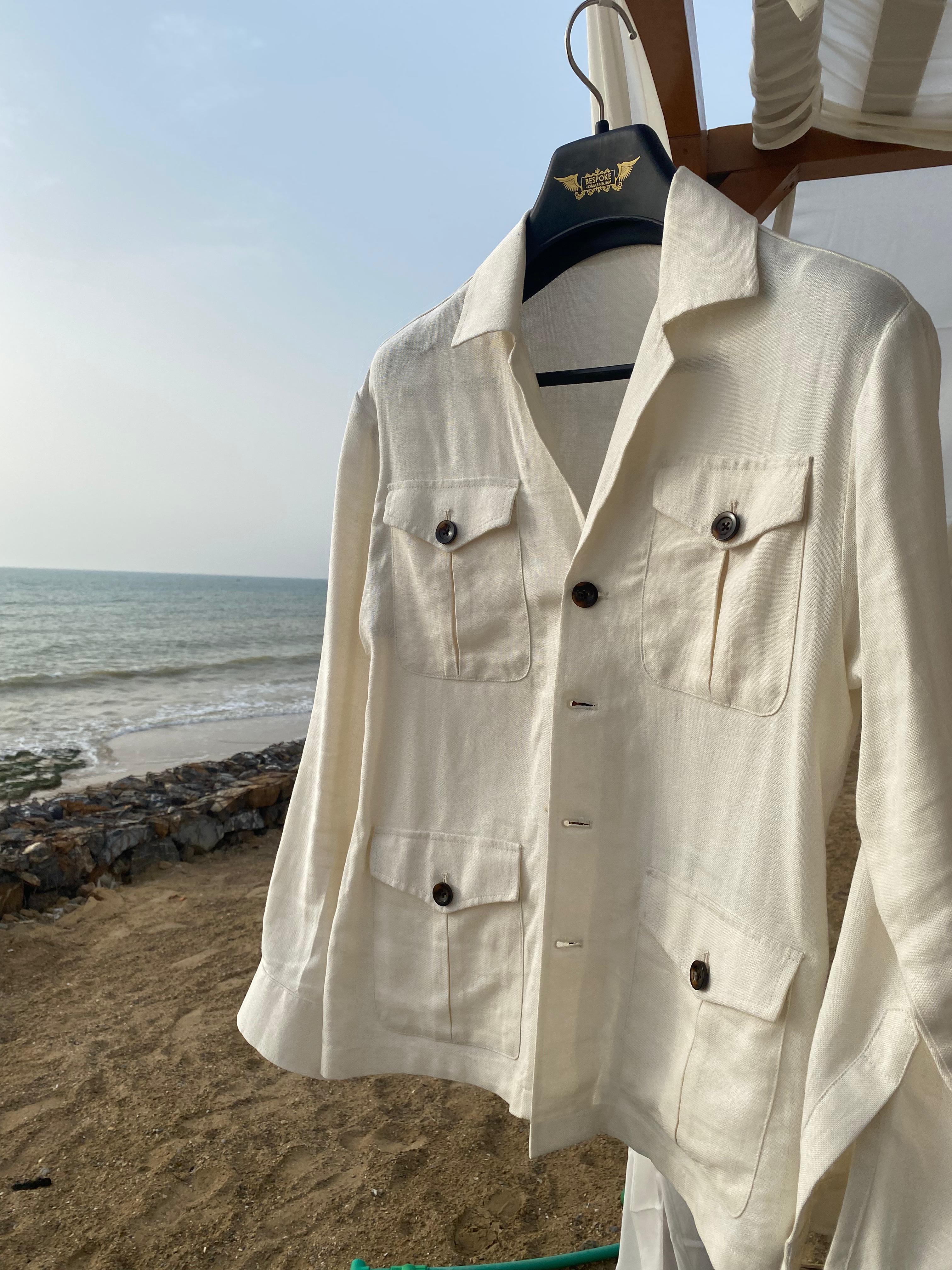  Off white Safari Linen Jacket on a hanger with a beach background